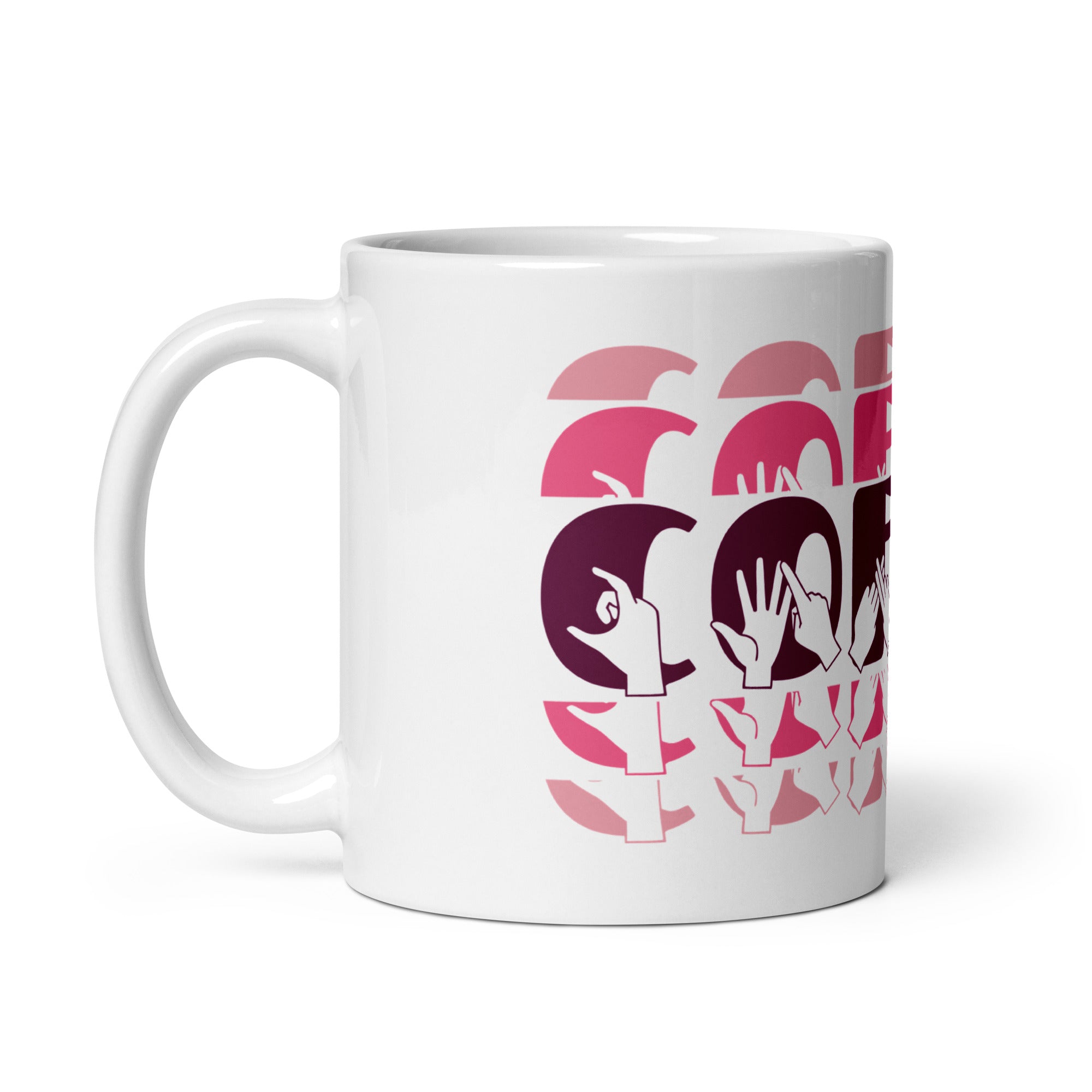 White mug featuring the phrase Coffee written in BSL Fingerspelling and Text wrapping around the mug in pink cutaway design. The mug handle is on the left hand side of the mug.