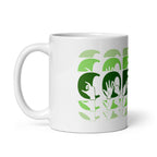White mug featuring the phrase Coffee written in BSL Fingerspelling and Text wrapping around the mug in green cutaway design. The mug handle is on the left hand side of the mug.