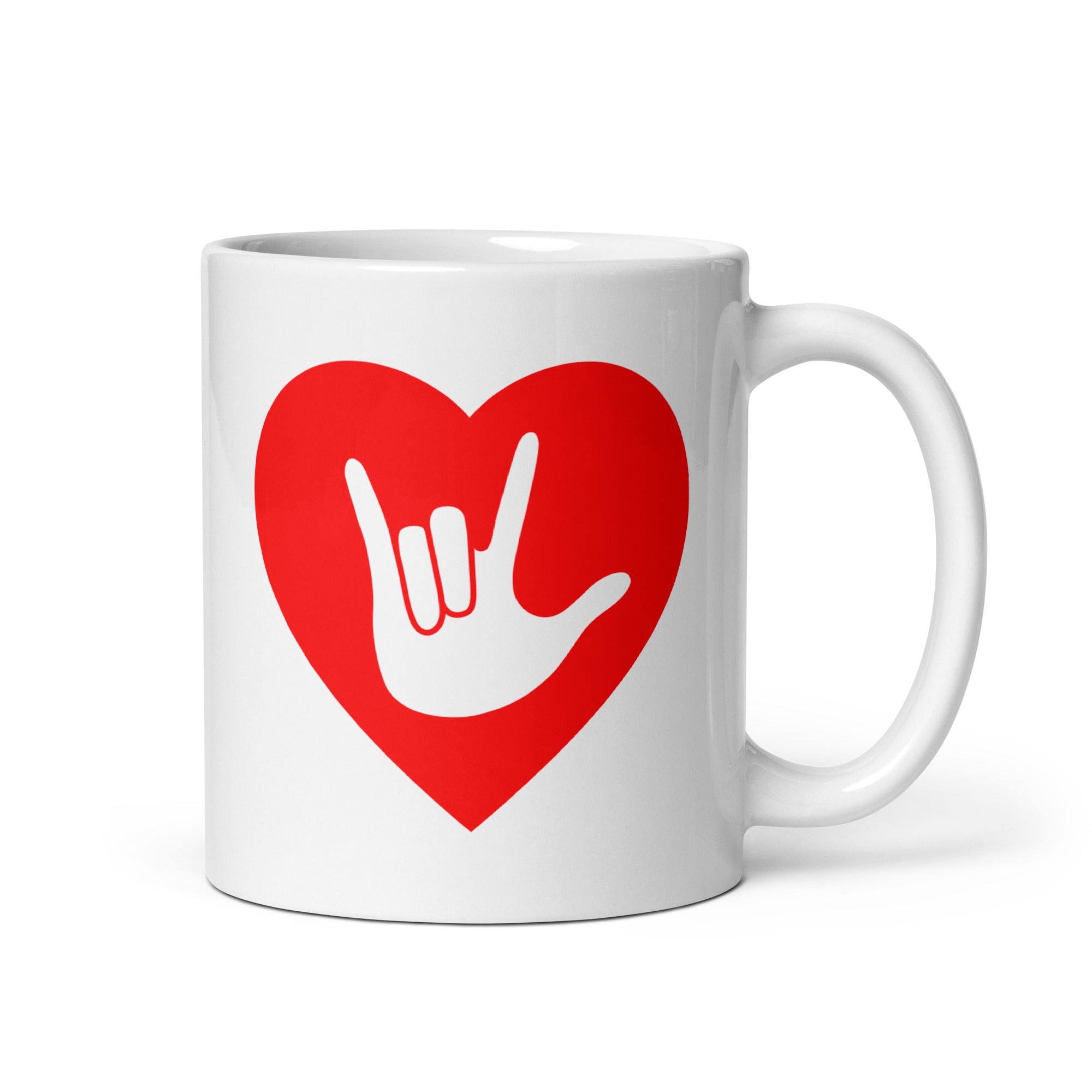 White mug with a red coloured heart design featuring the ASL sign for I Love You embedded in it. The mug handle is on the right hand side of the mug.