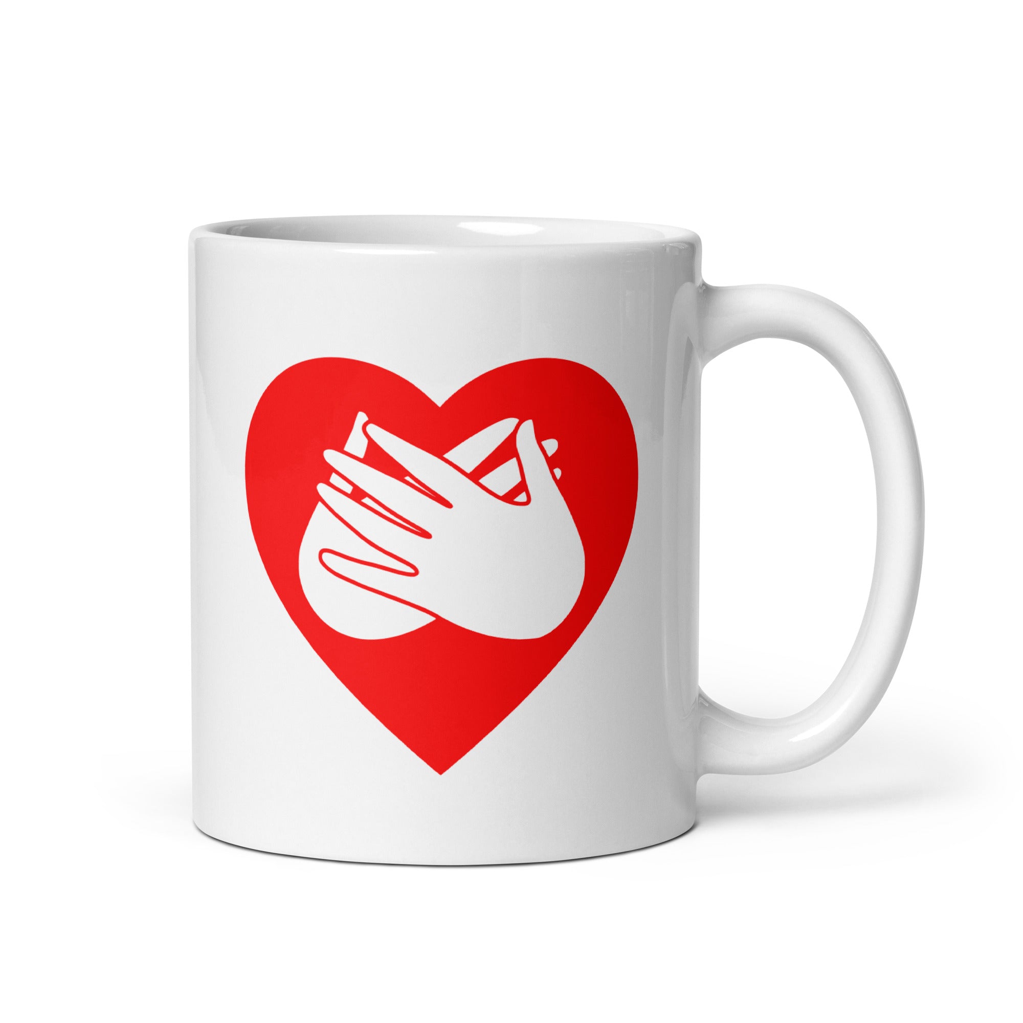 White mug with a red coloured heart design featuring the BSL sign for Love embedded in it. The mug handle is on the right hand side of the mug.