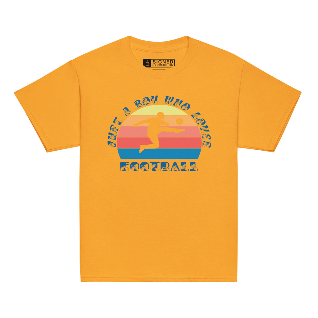 Gold t-shirt with the phrase "Just a Boy Who Loves Football" in BSL Fingerspelling and text featuring a colourful retro sunset and a silhouette of a boy kicking a football.