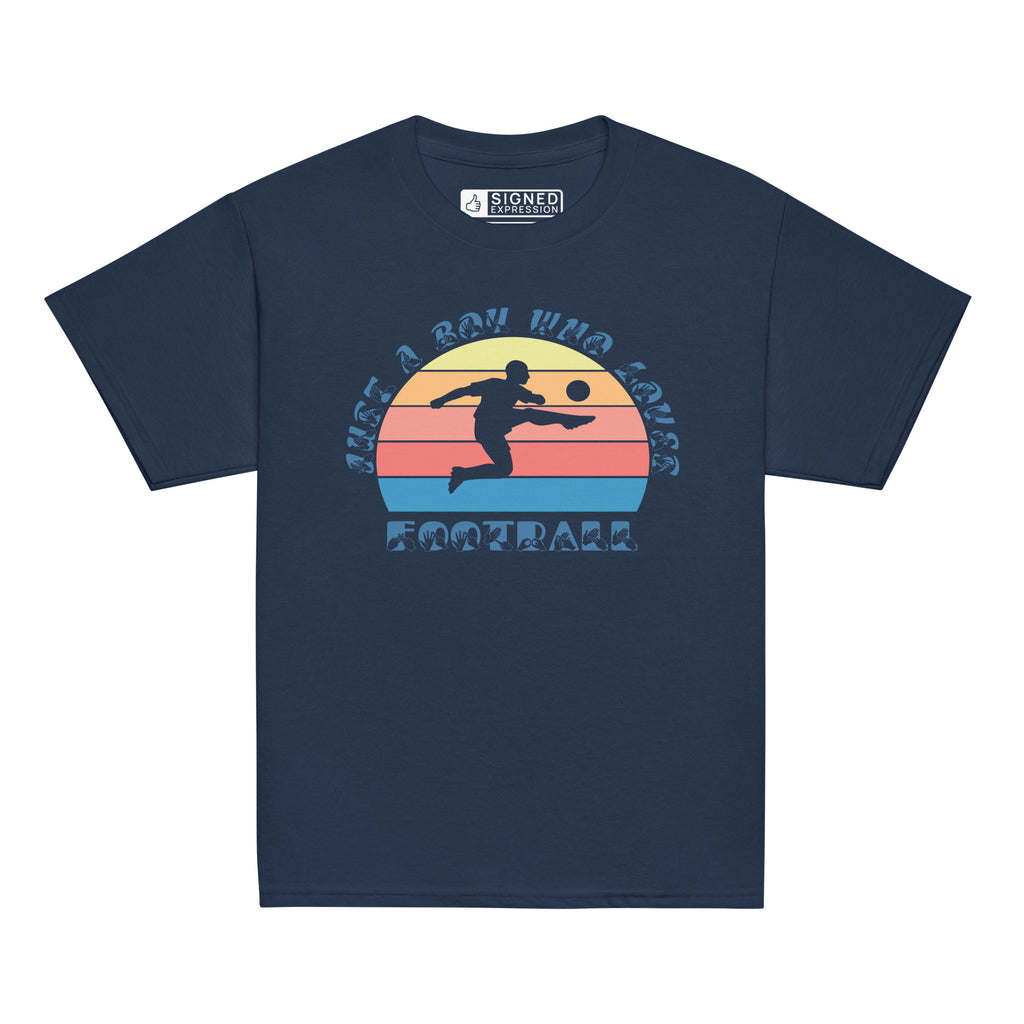 Navy t-shirt with the phrase "Just a Boy Who Loves Football" in BSL Fingerspelling and text featuring a colourful retro sunset and a silhouette of a boy kicking a football.