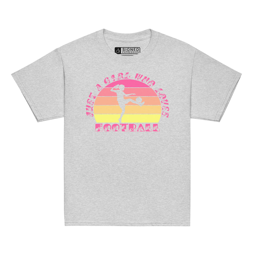 Sport grey t-shirt with the phrase "Just a Girl Who Loves Football" in BSL Fingerspelling and text featuring a colourful retro sunset and a silhouette of a boy kicking a football.