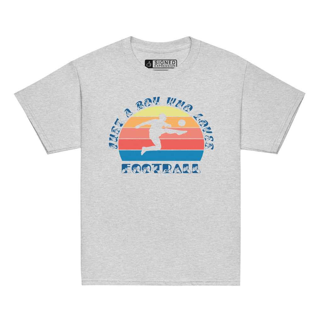 Sport grey t-shirt with the phrase "Just a Boy Who Loves Football" in BSL Fingerspelling and text featuring a colourful retro sunset and a silhouette of a boy kicking a football.